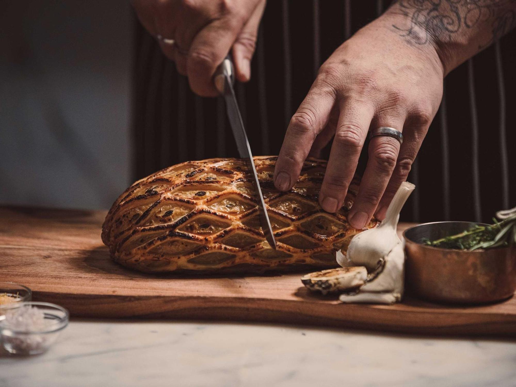 Horizon By Skycity Auckland Exteriör bild Chef preparing a whole roasted suckling pig